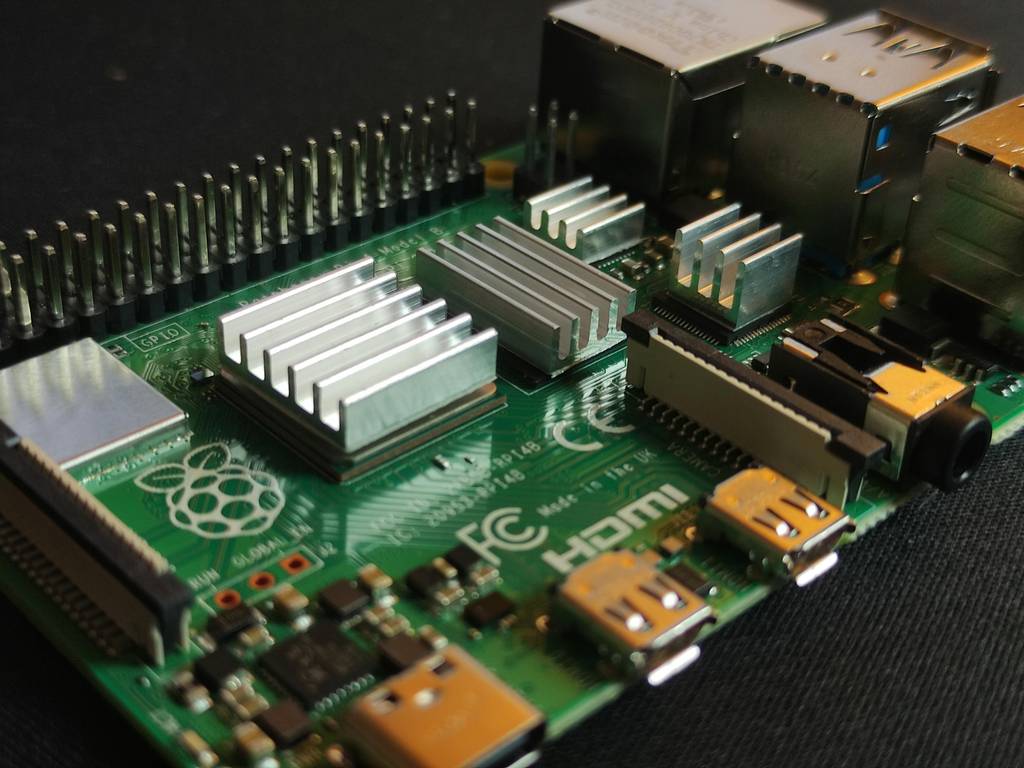 A Raspberry Pi single-board computer on a workbench, wired up as an edge device